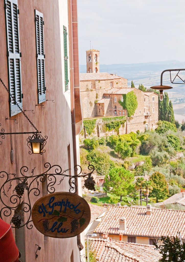 Sign for restaurant and view from Montalcino
