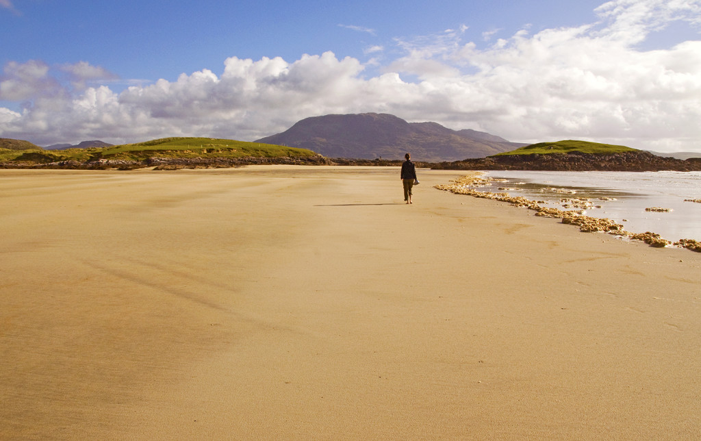 My friend walking down a desolate beach in County Mayo, Ireland