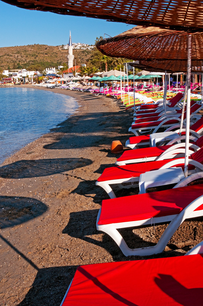 Colorful sun loungers on beach at Bitez, Bodrum Peninsula. Turkey