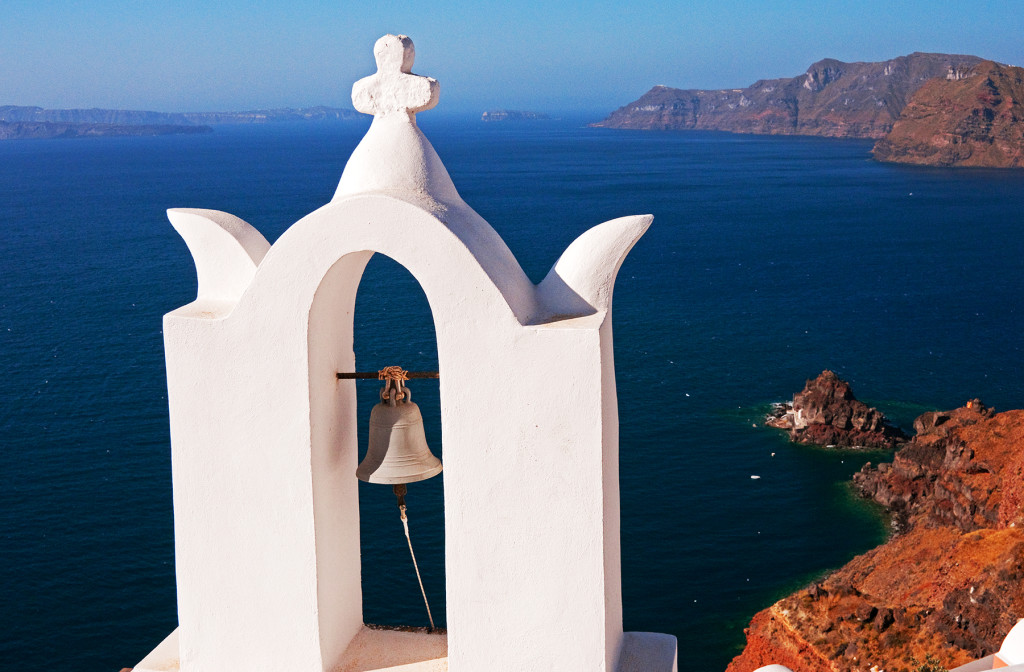 Church bell tower with Aegean Sea in background, Oia, Santorini, Greece