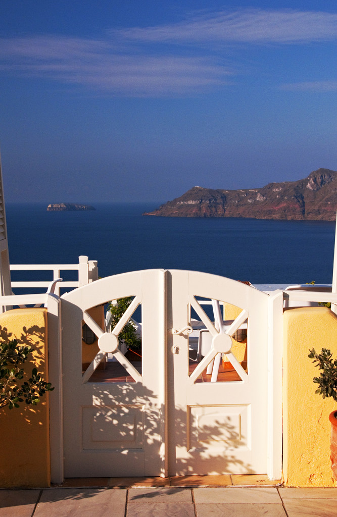White gate to hotel terrace with view, Oia, Santorini, Greece