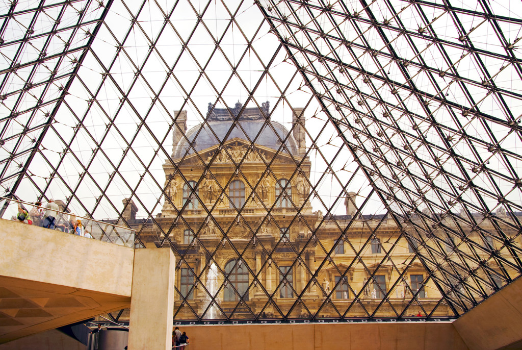 Looking out the glass pyramid of the Lourve lobby to the buildings of the Palais du Louvre, Paris, France