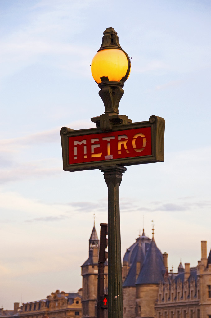 Metro sign on lampost at sunset, Paris, France