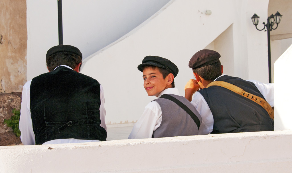 Young boy, part of a trio of musicians, at a wedding, Imerovigli, Santorini, Greece